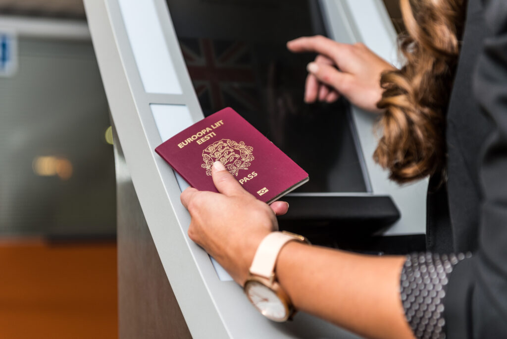 Mulher segura seu passaporte ao fazer check-in: visto E-2 é uma excelente opção para as franquias nos EUA